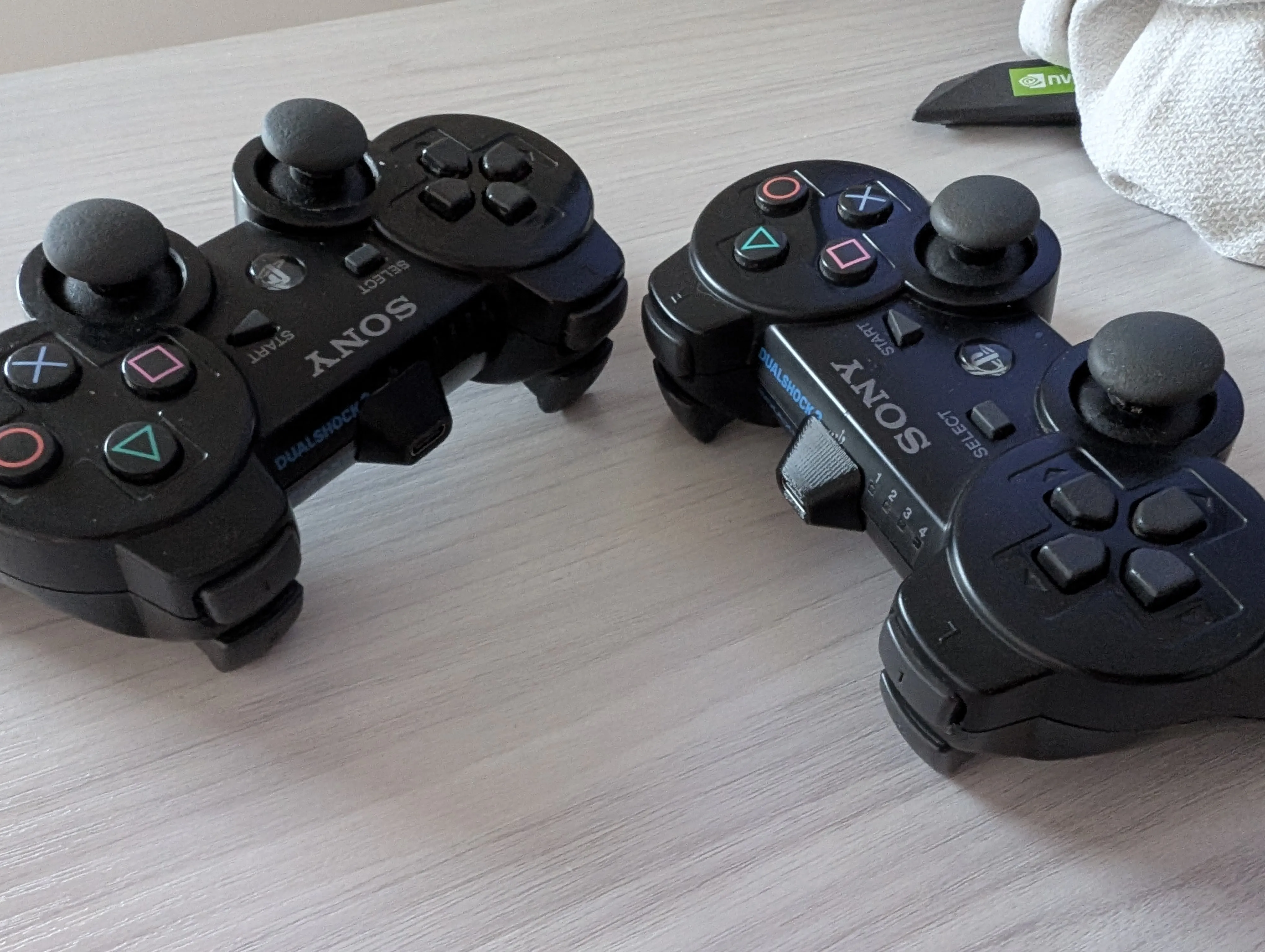 The PLab USB-C adapters plugged into the Dualshock 3s.