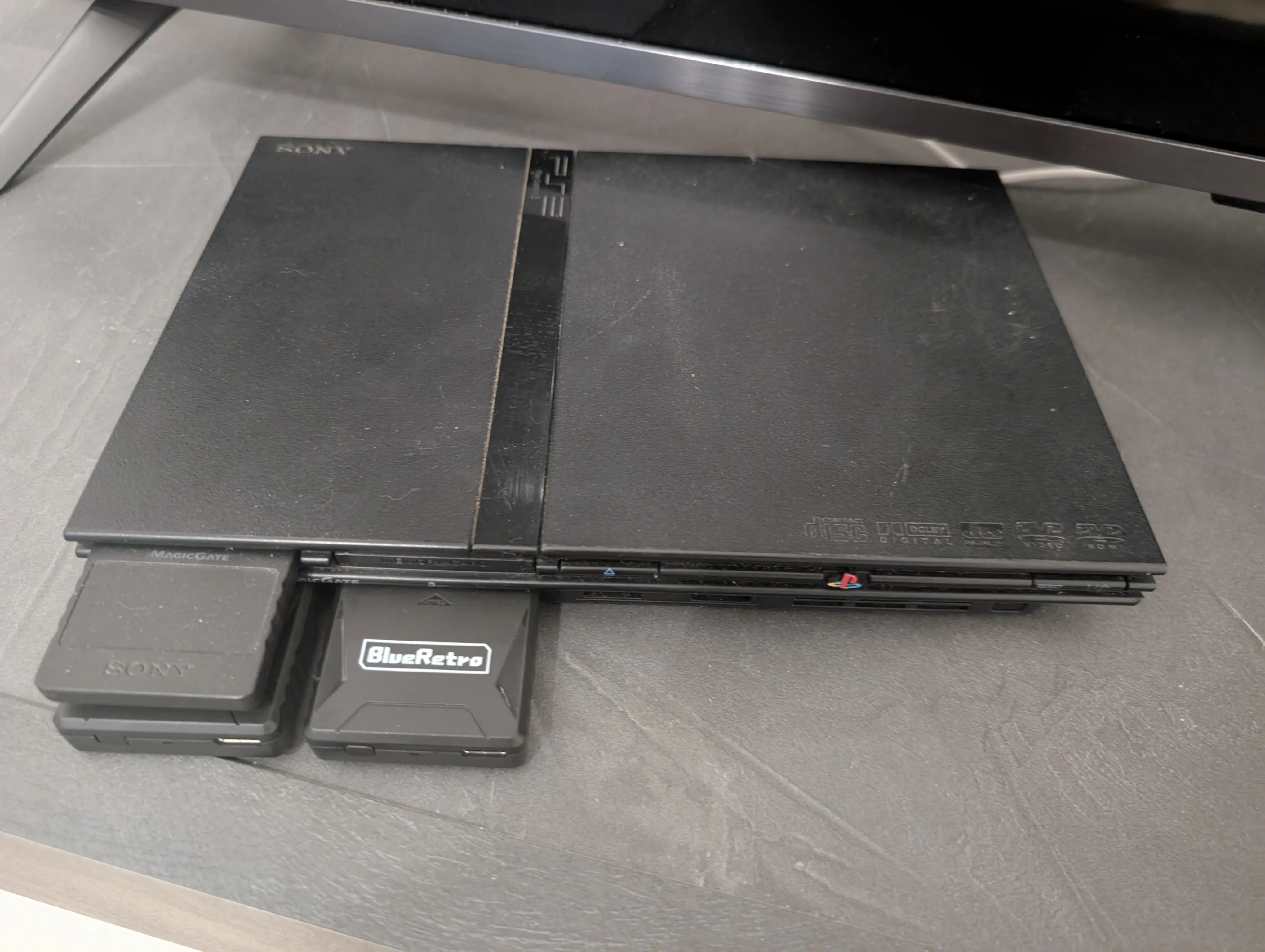 The PlayStation 2, sporting the BlueRetro adapters.